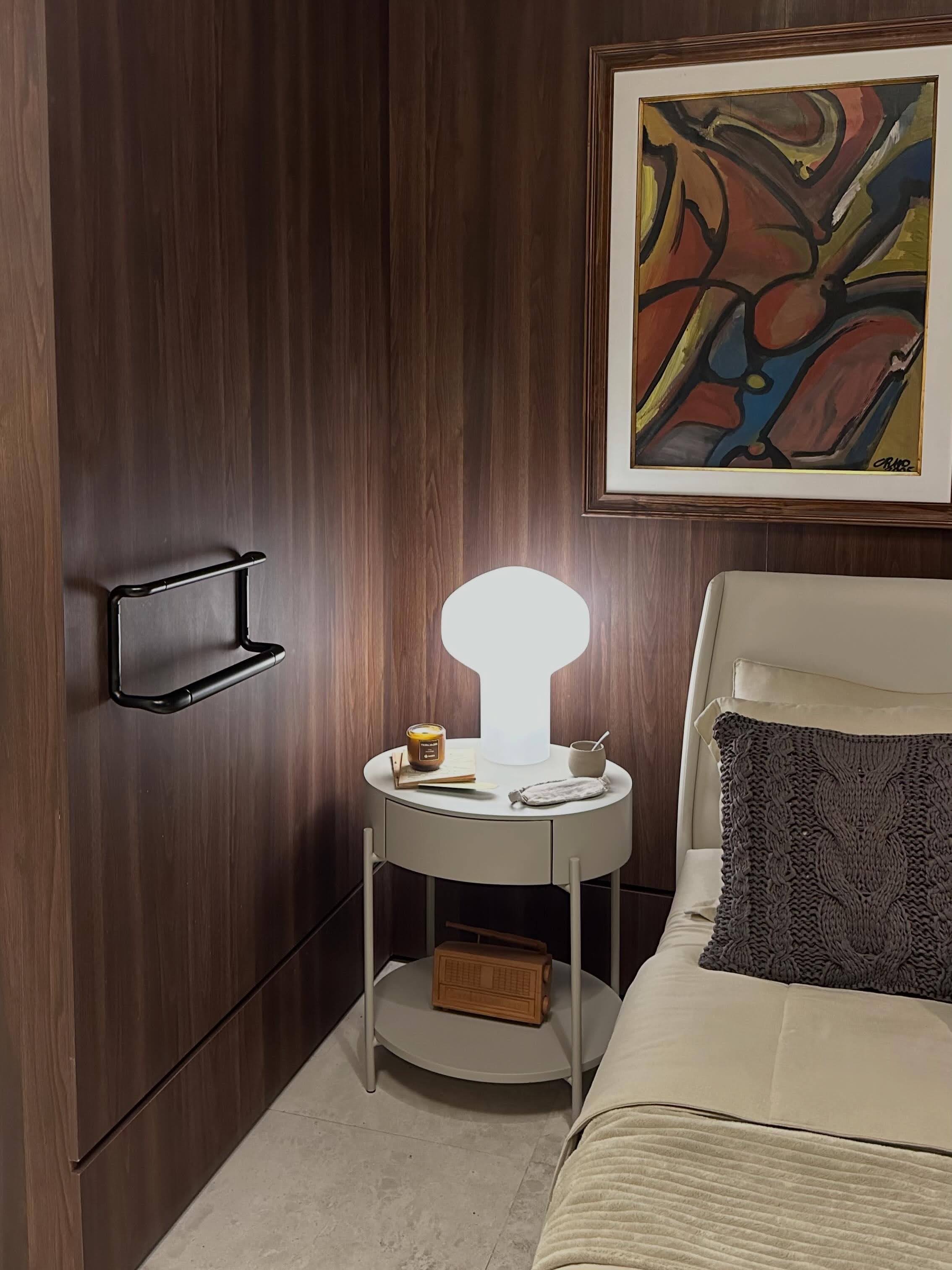 Ambiente de leitura da Casa Cura CasaCor — poltrona confortável e mesa lateral com livros, criando um espaço de bem-estar e presença humana no cuidado